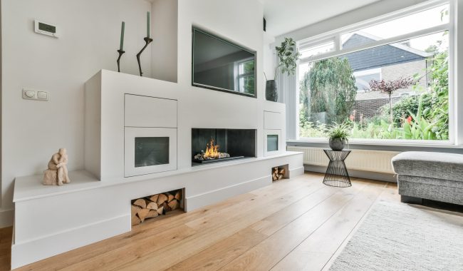 A kitchen with the furniture in it and the bright light coming from the window